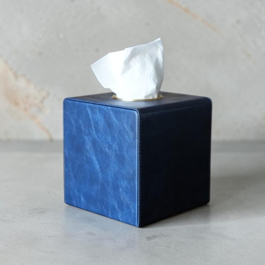 Square PU leather tissue box cover with gold-tone trim and magnetic closure by Connsole Casa