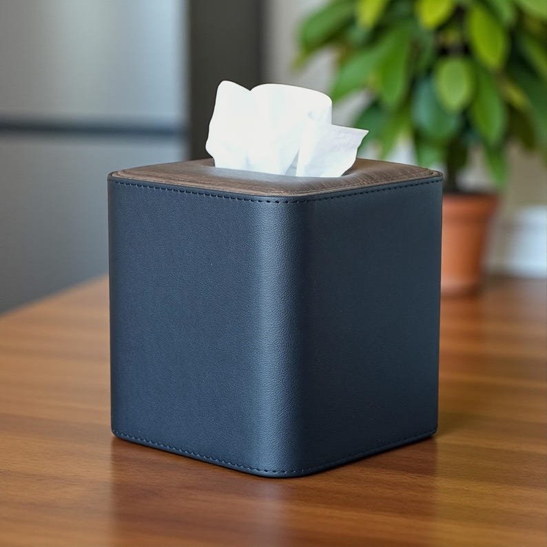 Square leather tissue box cover with gold-tone trim, handcrafted by Connsole Casa