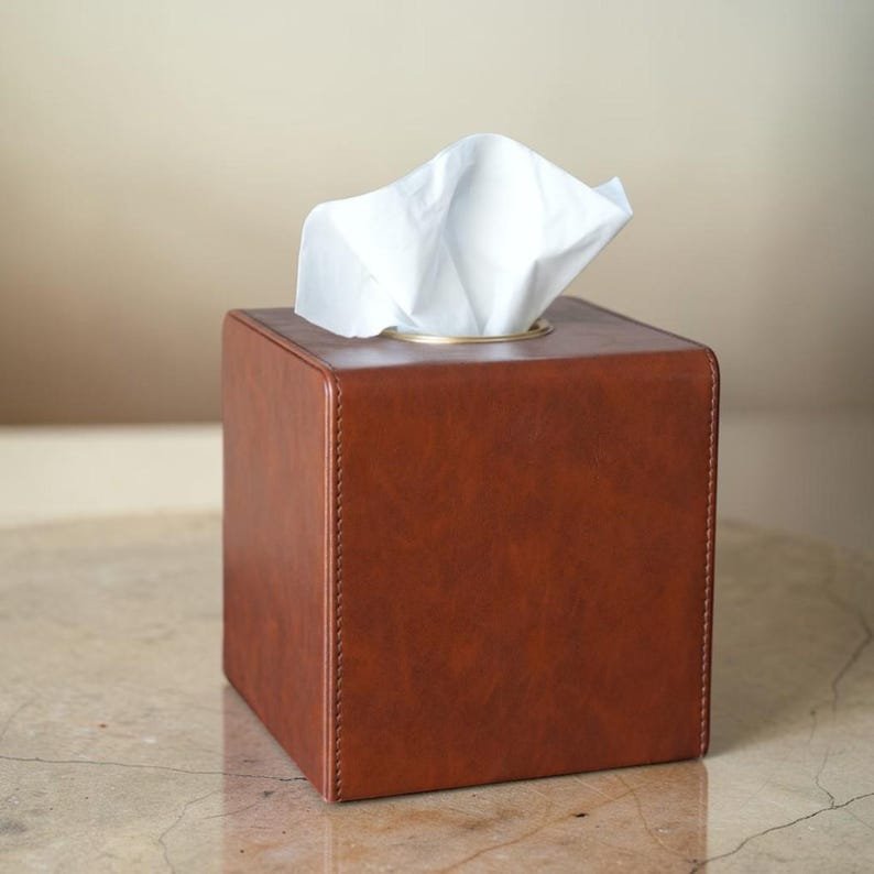 Handcrafted square leather tissue box cover with gold-tone trim by Connsole Casa